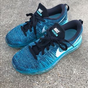 Blue women’s Nike Flyknit Max sneakers.